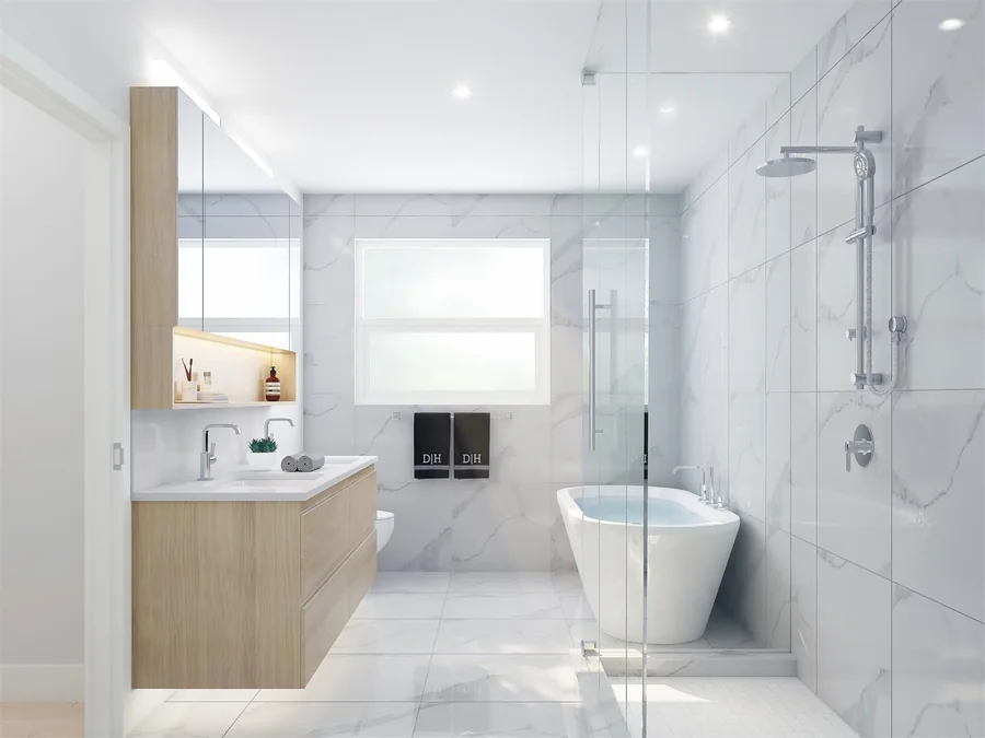 Bright bathroom with a freestanding bath, glazed shower and pale vanity.